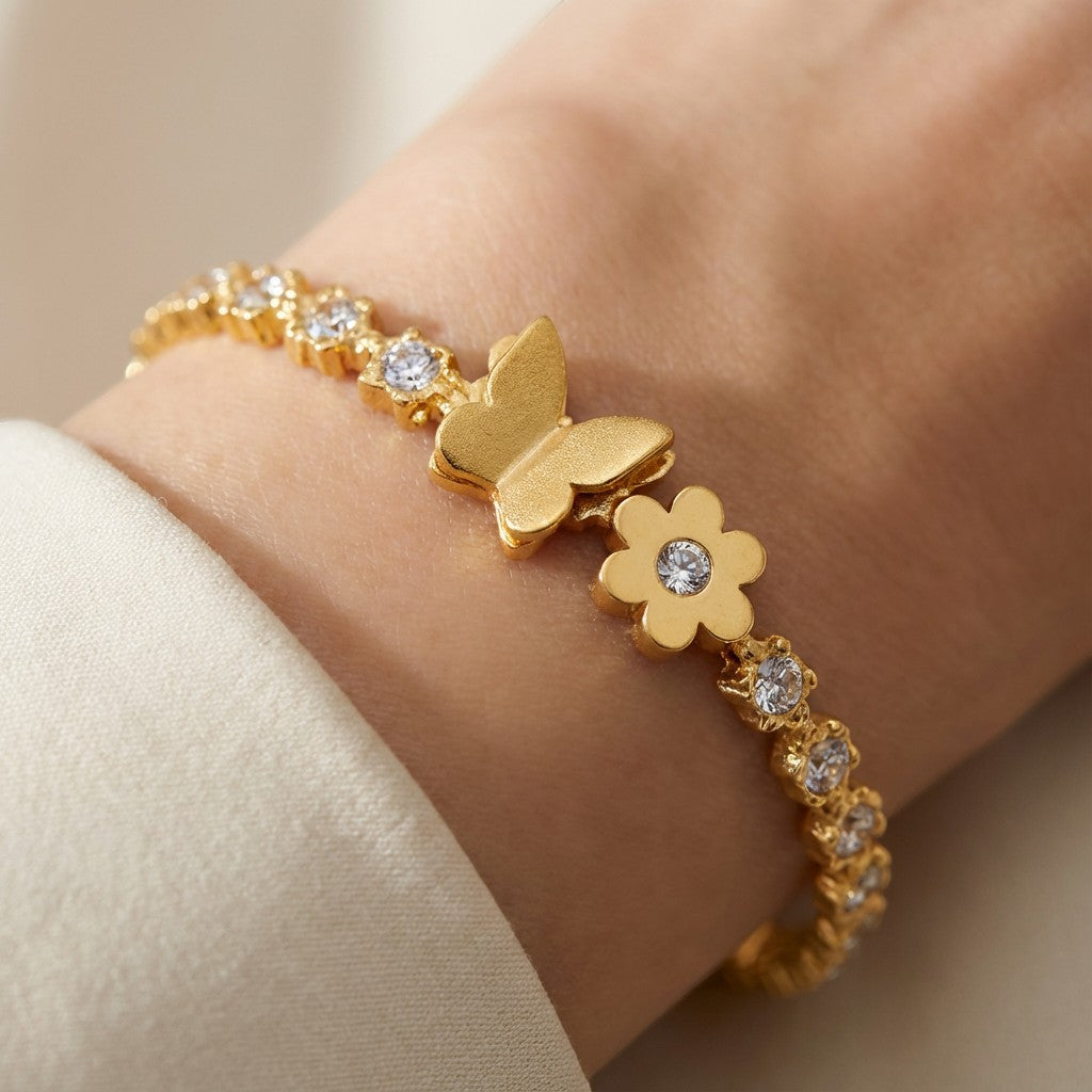 TITLIYA gold-plated bracelet featuring a butterfly and flower motif with sparkling crystal accents on a wrist.