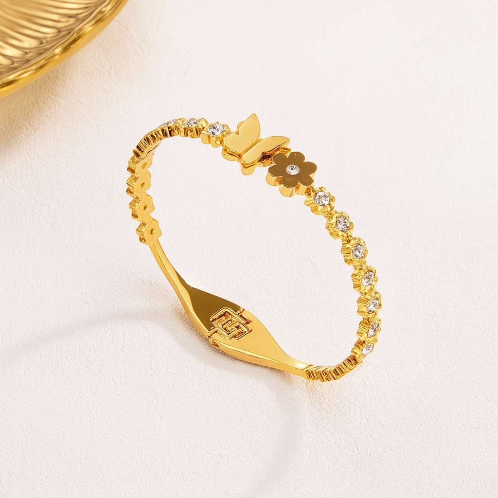 TITLIYA gold-plated bracelet featuring a delicate butterfly and flower motif with sparkling crystal accents.