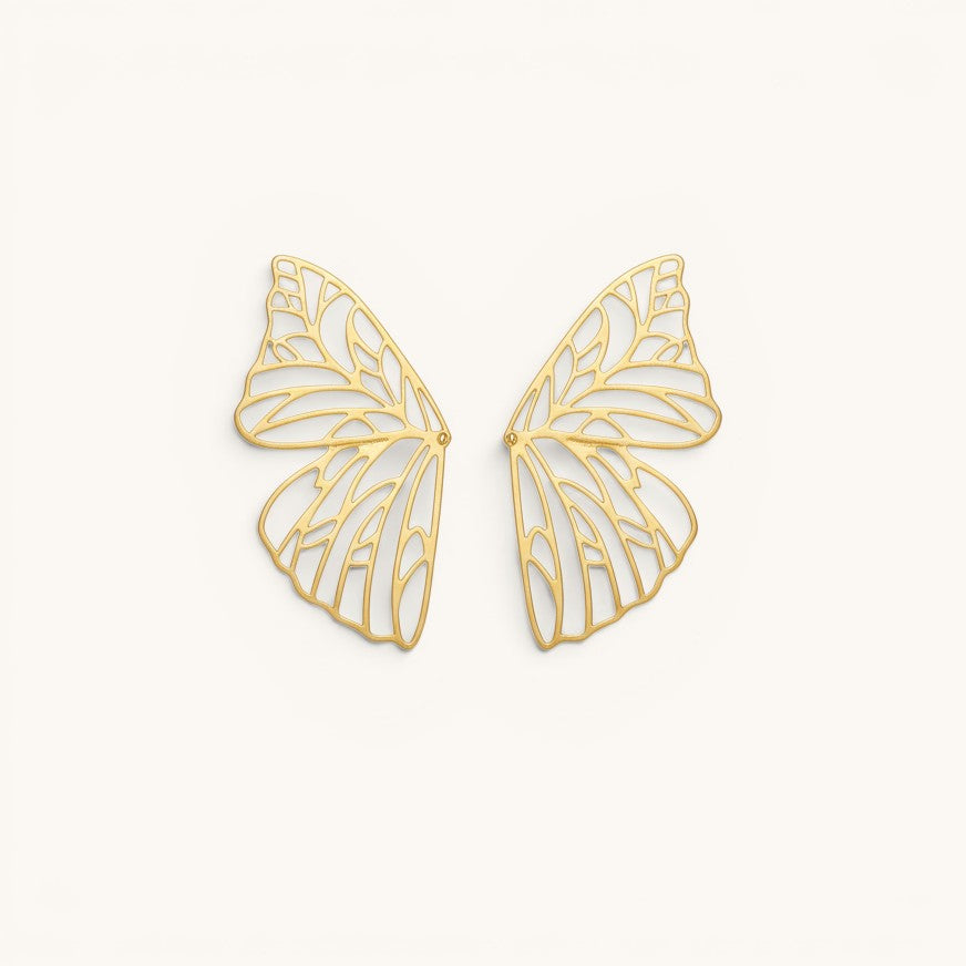 TITLIYA gold-plated butterfly wing hoop earrings with intricate filigree cut-out design on a neutral background.