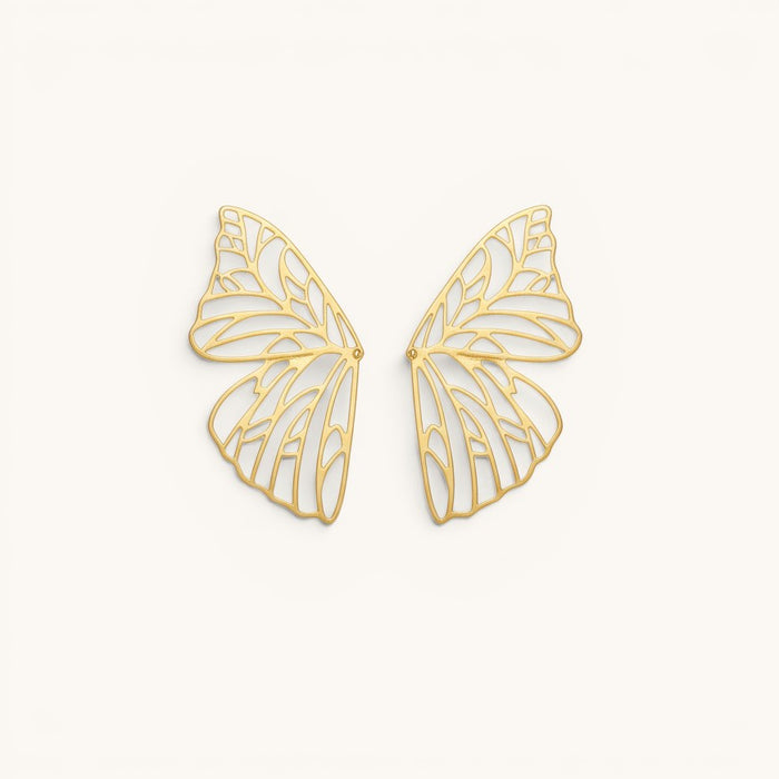 TITLIYA gold-plated butterfly wing hoop earrings with intricate filigree cut-out design on a neutral background.