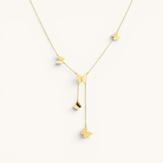 TITLIYA gold glitter butterfly lariat necklace featuring delicate dangling butterfly charms on a fine chain.