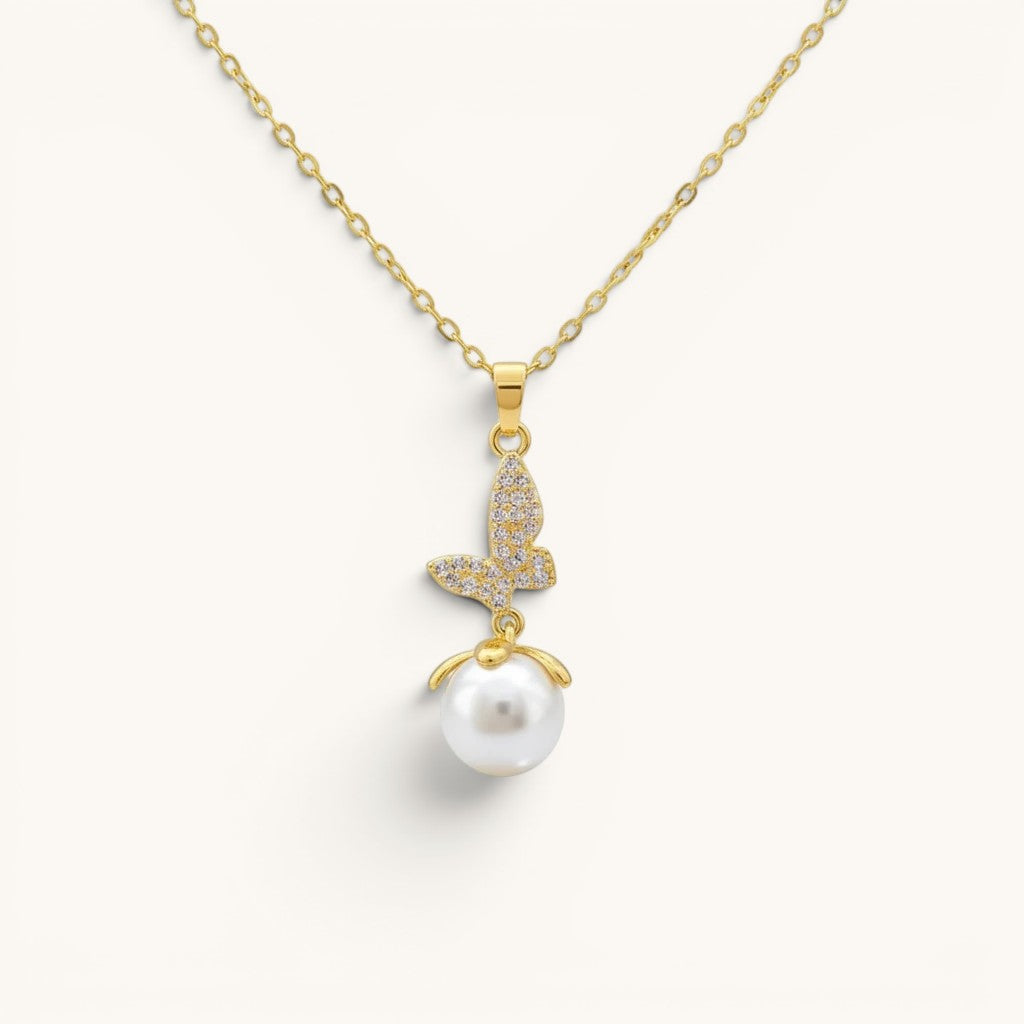 TITLIYA gold-toned butterfly pendant necklace featuring a crystal-encrusted butterfly charm and a white pearl drop.