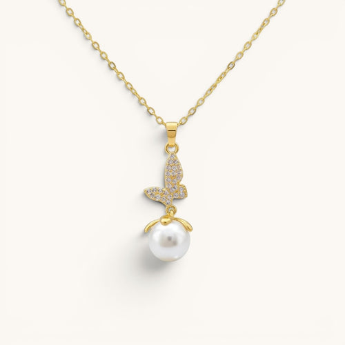 TITLIYA gold-toned butterfly pendant necklace featuring a crystal-encrusted butterfly charm and a white pearl drop.