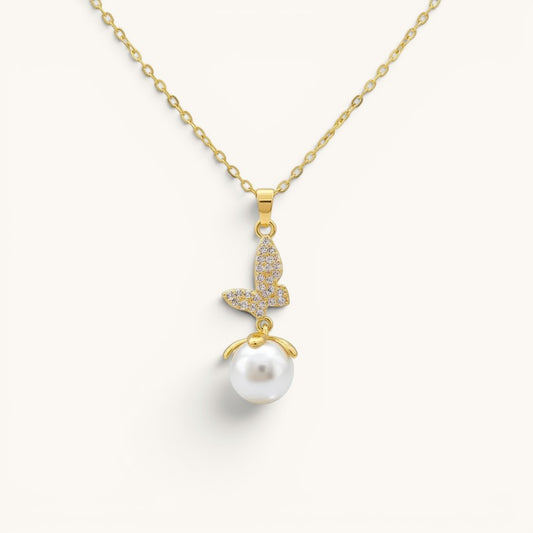 TITLIYA gold-toned butterfly pendant necklace featuring a crystal-encrusted butterfly charm and a white pearl drop.