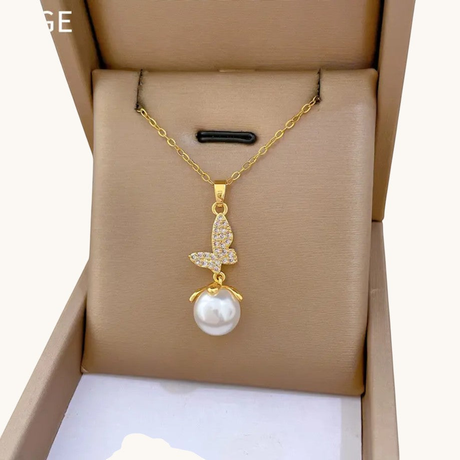 TITLIYA gold-toned butterfly pendant necklace featuring a crystal-encrusted butterfly charm and a white pearl drop.