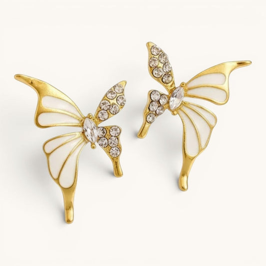 TITLIYA gold-plated butterfly stud earrings featuring white enamel wings and sparkling crystal accents.