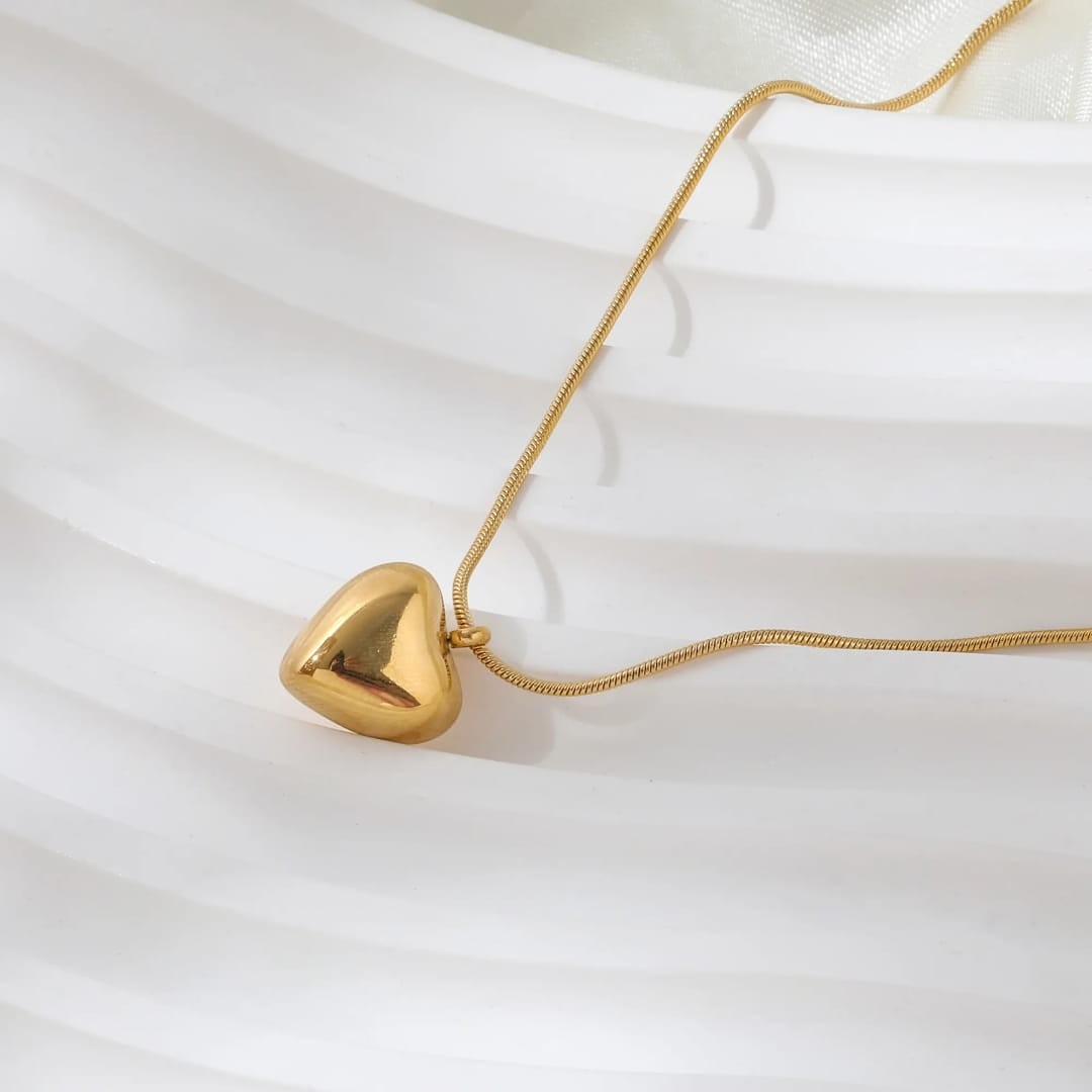 TITLIYA gold-toned heart pendant necklace with a delicate snake chain, perfect for elegant daily wear.