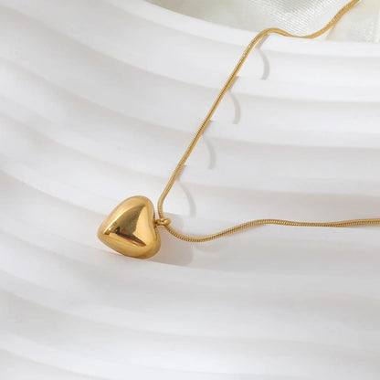 TITLIYA gold-toned heart pendant necklace with a delicate snake chain, perfect for elegant daily wear.