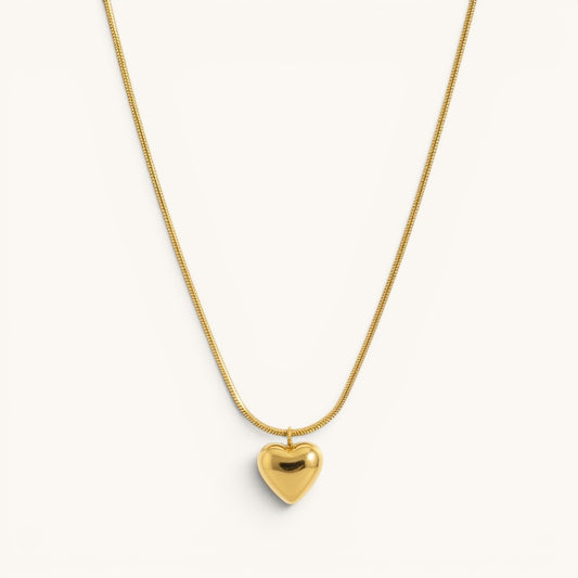 TITLIYA gold-toned heart pendant necklace on a sleek snake chain, perfect for everyday elegant wear.