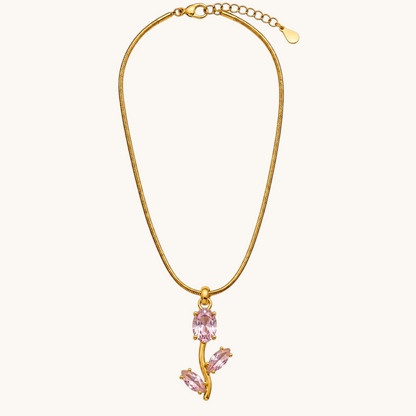 TITLIYA gold-tone snake chain necklace featuring a delicate tulip pendant with a light pink oval stone and accents.