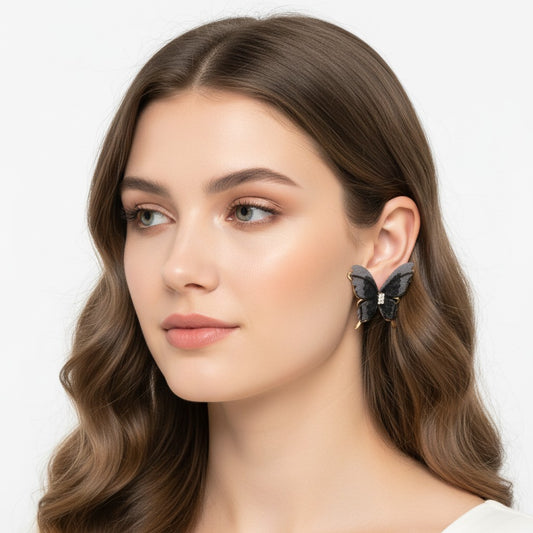 Model wearing TITLIYA gold-plated Korean style butterfly earrings with dark grey fabric wings and crystal accents.