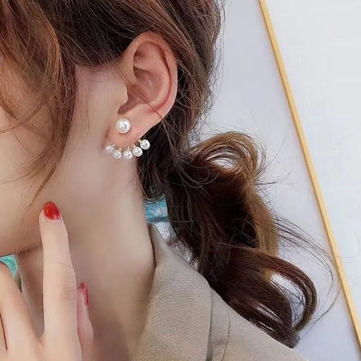 TITLIYA gold plated needle pearl earrings featuring a fan-shaped design worn by a woman for an elegant look.