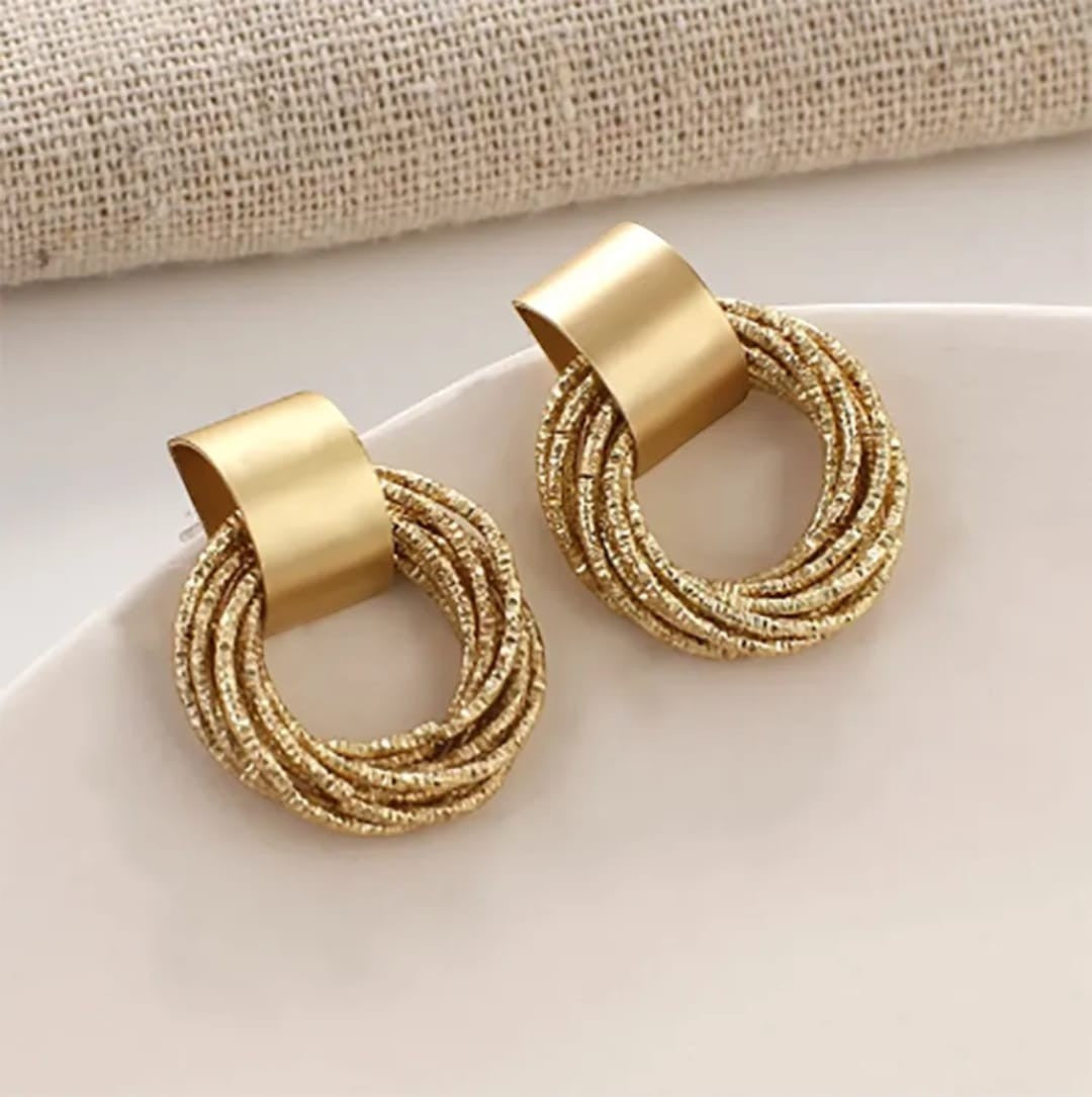 TITLIYA gold plated spiral hoop earrings with a textured circular design and smooth metal top bar for elegant wear.