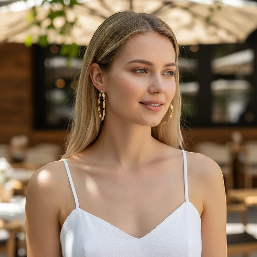 A woman wearing TITLIYA golden round twisted hoop earrings, perfect for daily elegance and special occasions.