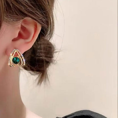 TITLIYA elegant gold-tone stud earring featuring a vibrant green stone and sparkling crystal accents on a model