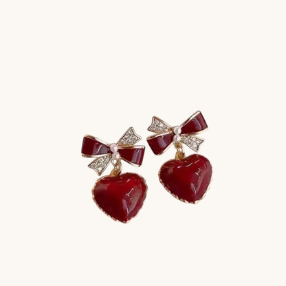 TITLIYA brownish red heart-shaped drop earrings with crystal-accented bows and pearl details for elegant daily wear.