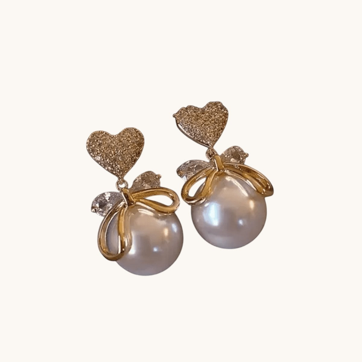 TITLIYA gold-tone heart earrings with white faux pearls and delicate bow accents for an elegant, stylish look.