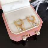 TITLIYA gold-tone Korean hanging earrings featuring delicate chains and sparkling diamond-like crystals in a pink box.