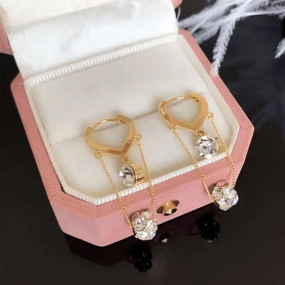 TITLIYA gold-tone Korean hanging earrings featuring delicate chains and sparkling diamond-like crystals in a pink box.
