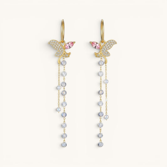 TITLIYA long gold butterfly earrings with crystal pavé, pink accents, and dangling beaded tassel chains.