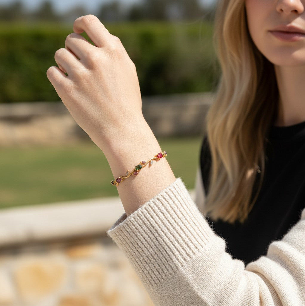TITLIYA RGL multicolour tulip bracelet with gemstone floral accents on a woman wearing a cream sweater.