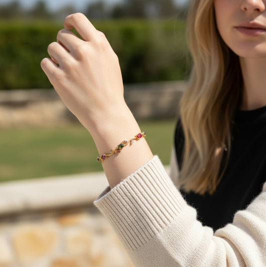 TITLIYA RGL multicolour tulip bracelet with gemstone floral accents on a woman wearing a cream sweater.