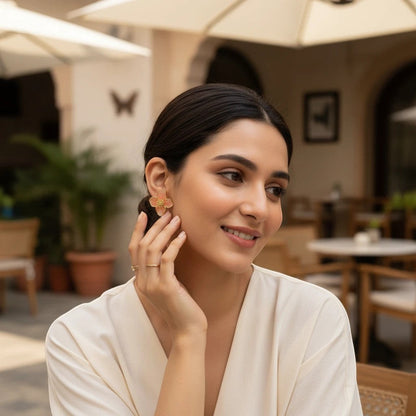 Woman wearing elegant orange flower earrings by TITLIYA, perfect for daily wear or special occasions.