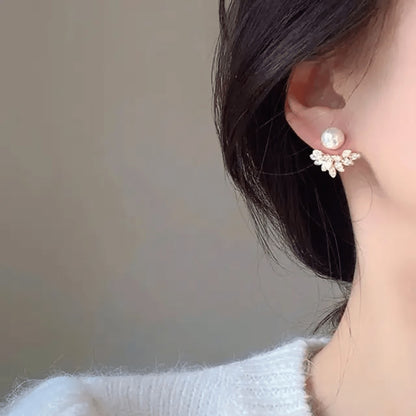 TITLIYA Pear Leaf Korean stud earrings featuring a white pearl and crystal-encrusted leaf design on a model.