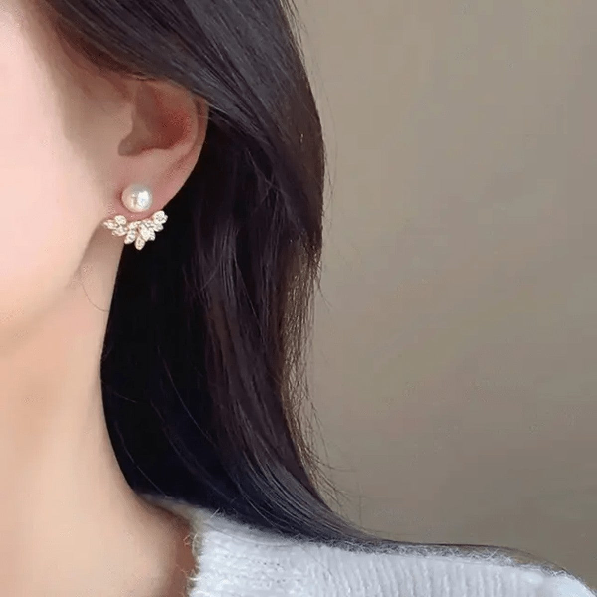 TITLIYA Pear Leaf Korean stud earrings featuring a white pearl and crystal-embellished leaf design on a model.