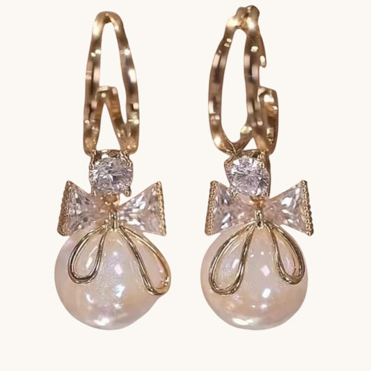 TITLIYA gold-tone drop earrings featuring a white pearl, crystal-embellished bow, and elegant Korean-style design.