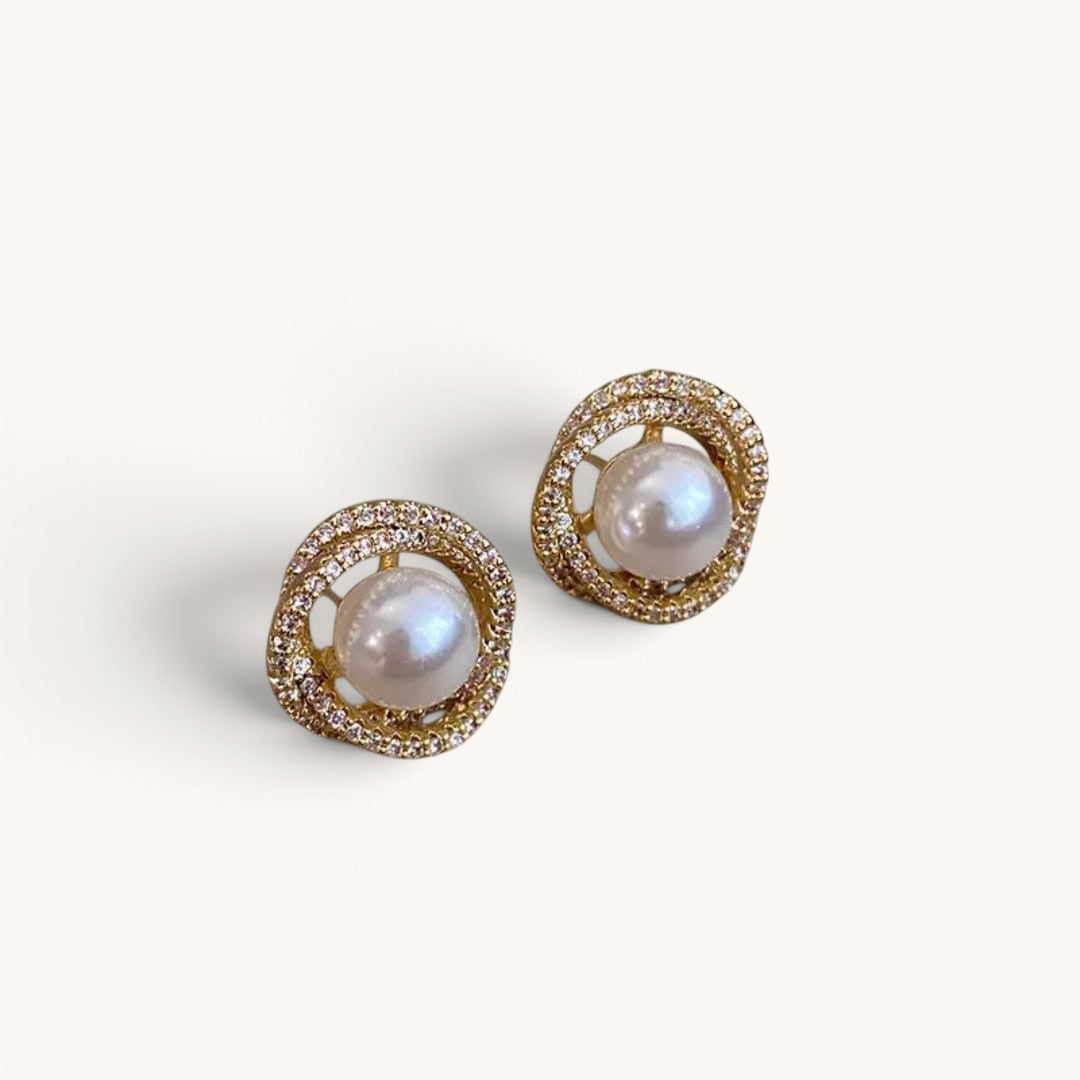 TITLIYA pearl and diamond stud earrings featuring a central white pearl surrounded by a gold-tone crystal halo.