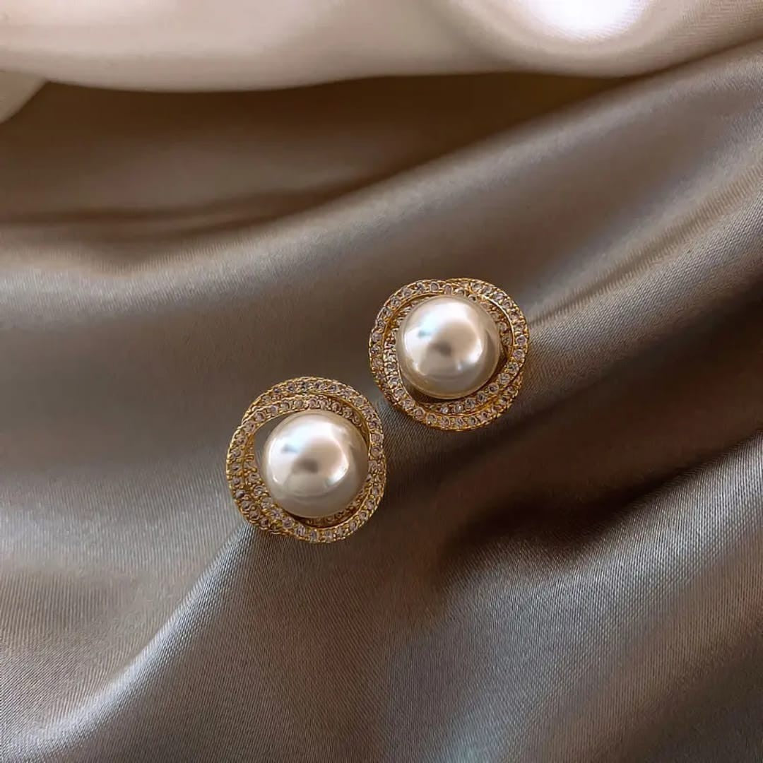TITLIYA elegant gold-tone stud earrings featuring a central white pearl surrounded by a halo of sparkling diamonds.