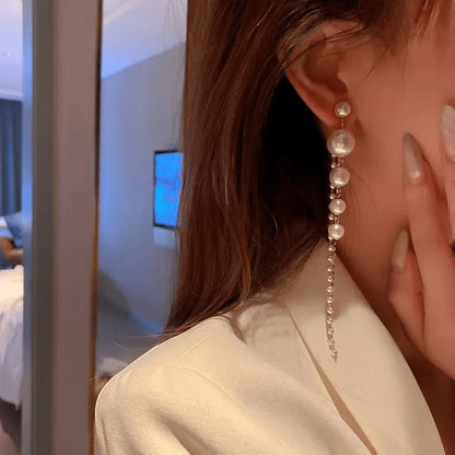 TITLIYA elegant long pearl drop Korean style earrings worn by a woman in a white blazer for a sophisticated look.