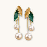 TITLIYA gold-tone drop earrings featuring green and yellow enamel leaves with dangling white pearl tassels.