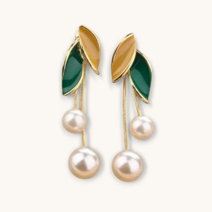 TITLIYA gold-tone drop earrings featuring green and yellow enamel leaves with dangling white pearl tassels.