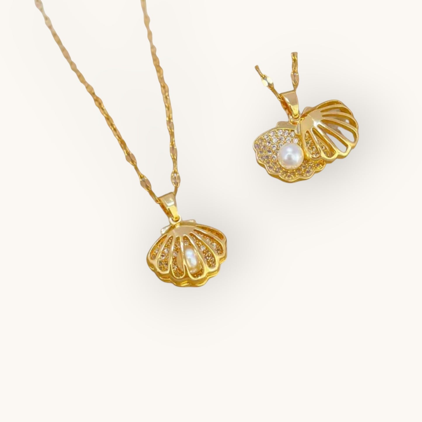 TITLIYA gold-tone shell pendant necklace featuring a central pearl and sparkling crystal accents for elegant wear.