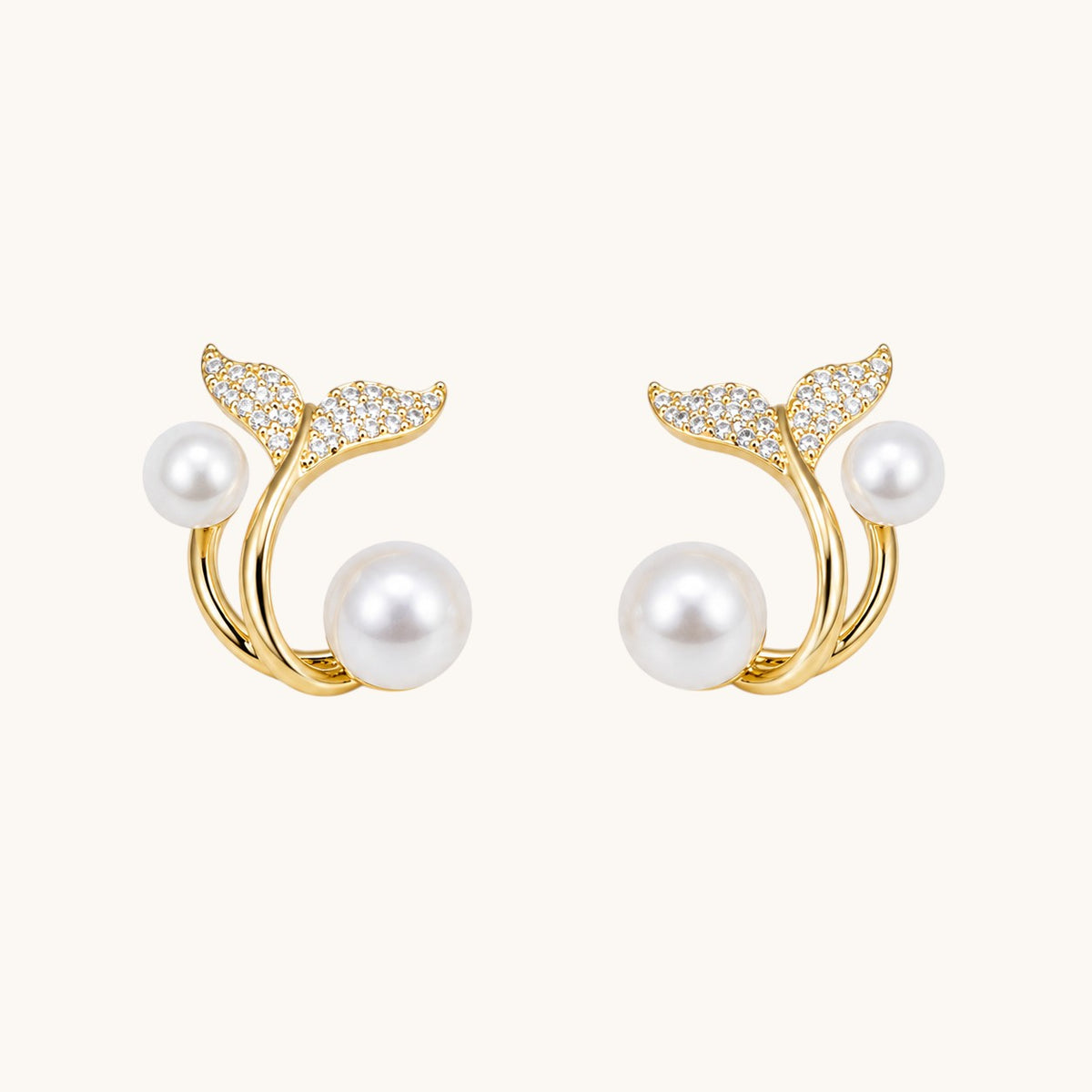 TITLIYA gold-tone whale tail earrings featuring white pearls and sparkling cubic zirconia accents.