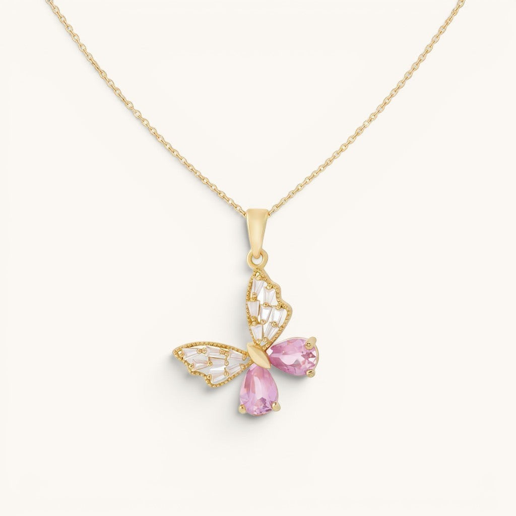 TITLIYA gold butterfly pendant necklace featuring pink teardrop crystals and clear baguette stones on a delicate chain.