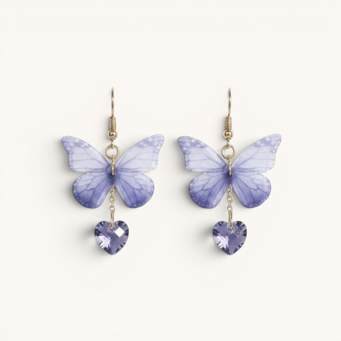 TITLIYA purple butterfly earrings with soft gradient wings and heart-shaped crystal drops on gold-tone hooks.