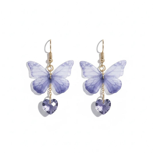 TITLIYA purple butterfly earrings with soft fabric wings and dangling heart-shaped crystal charms on gold hooks.