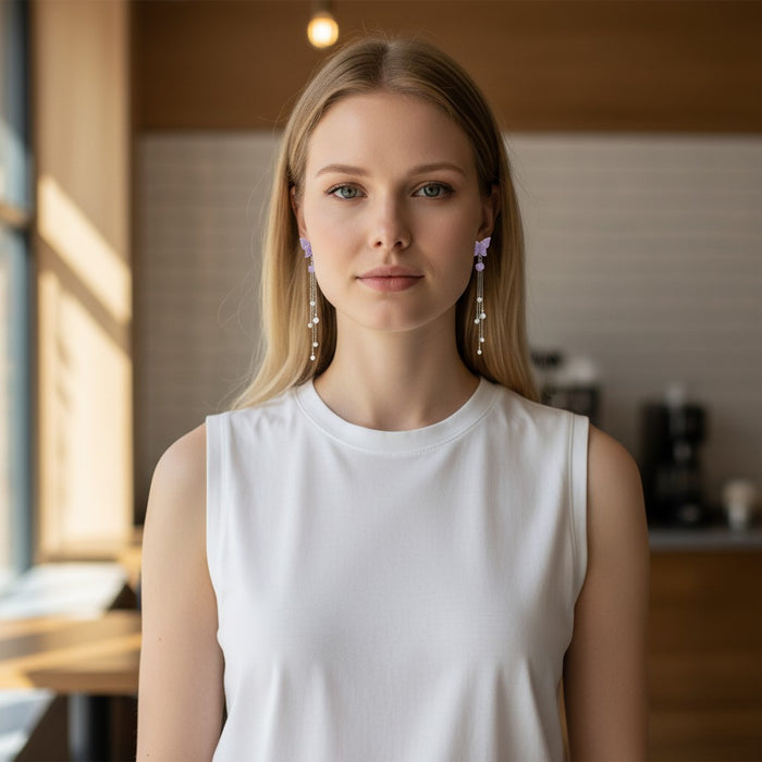Woman wearing TITLIYA purple butterfly-inspired Korean-style drop earrings with delicate silver chains and beads.