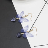 TITLIYA purple butterfly earrings with translucent wings and heart-shaped crystal drops on gold-tone hooks.