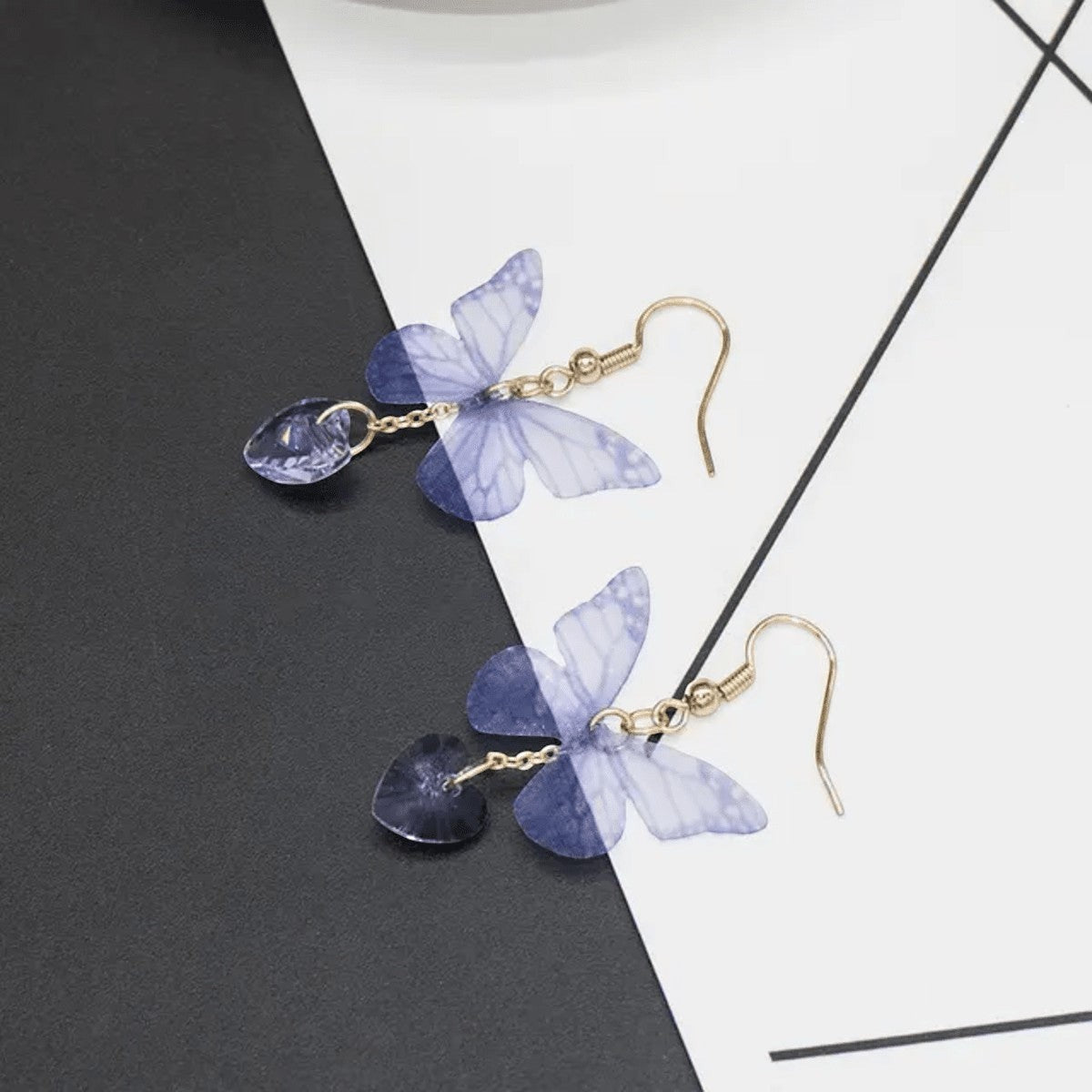 TITLIYA purple butterfly earrings with translucent wings and heart-shaped crystal drops on gold-tone hooks.