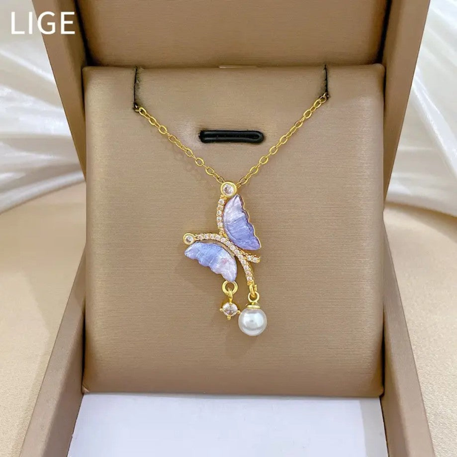 TITLIYA gold-tone butterfly pendant necklace with purple zircon wings, sparkling accents, and a delicate pearl drop.