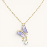 TITLIYA gold-tone butterfly pendant with purple zircon wings, sparkling crystals, and a delicate pearl drop necklace.
