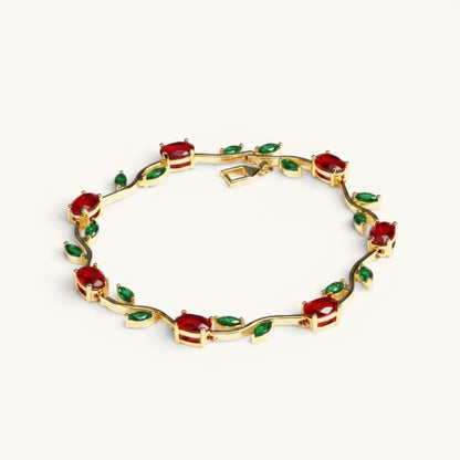 TITLIYA gold-tone vine bracelet featuring red tulip-inspired stones and green leaf accents in a floral design.