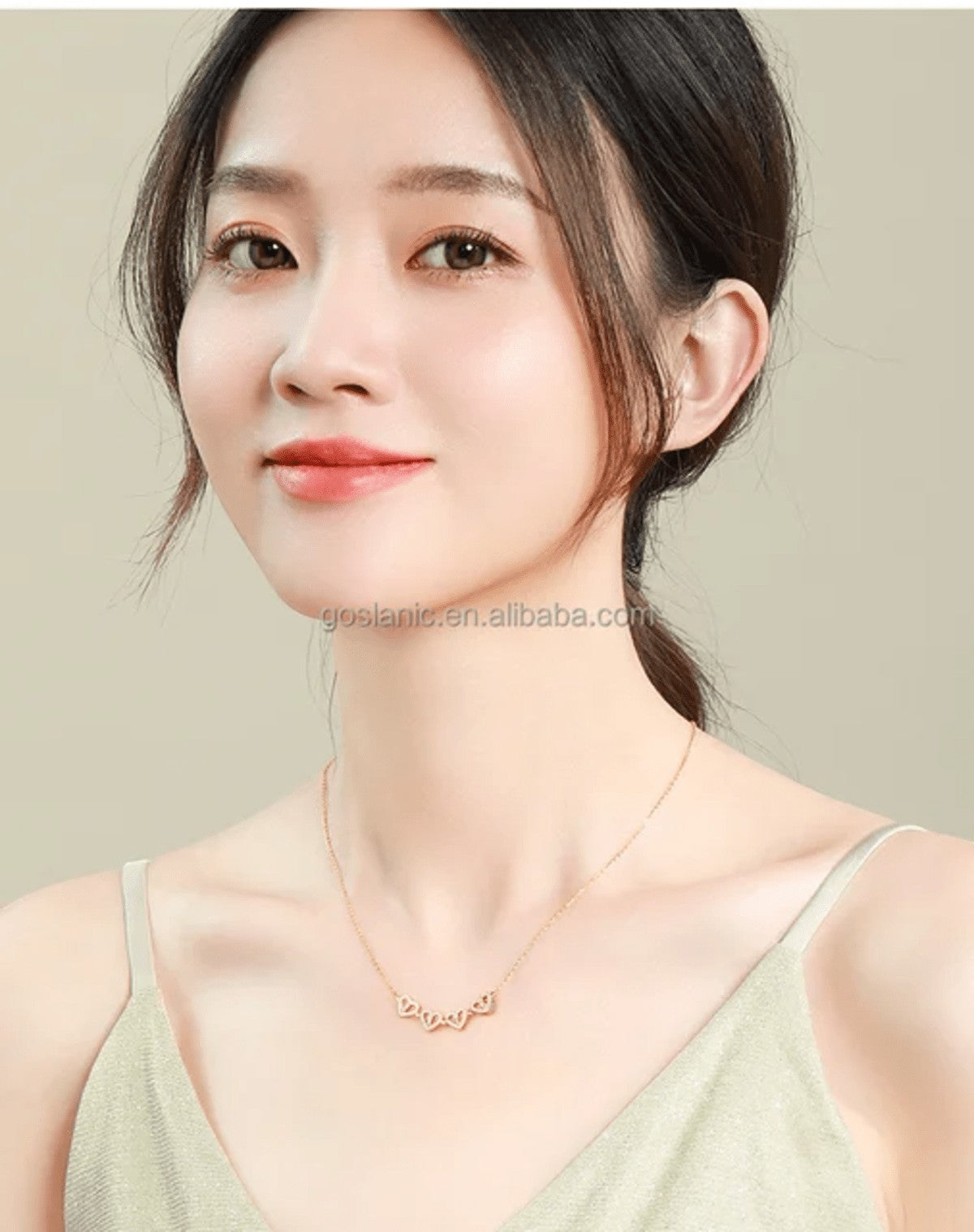 TITLIYA rose gold magnetic four-heart pendant necklace worn by a woman, elegant jewelry for daily wear.