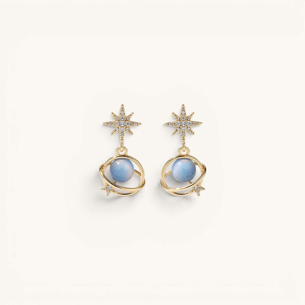 TITLIYA gold-tone Saturn earrings with blue spherical beads, star accents, and sparkling crystals for elegant wear.