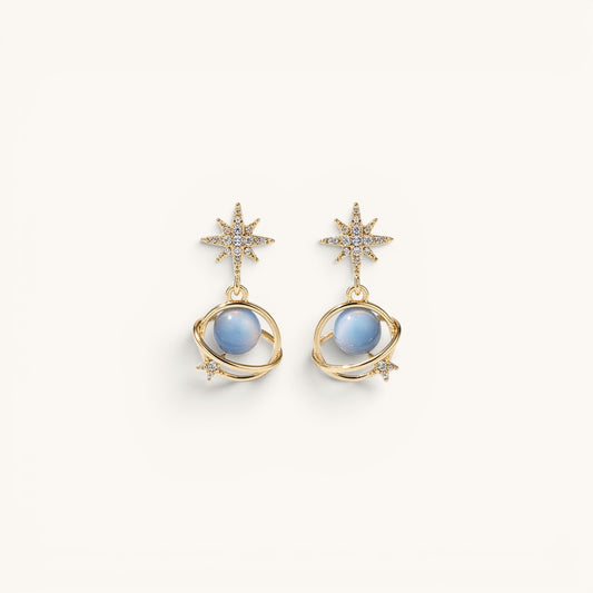 TITLIYA gold-tone Saturn earrings with blue spherical beads, star accents, and sparkling crystals for elegant wear.