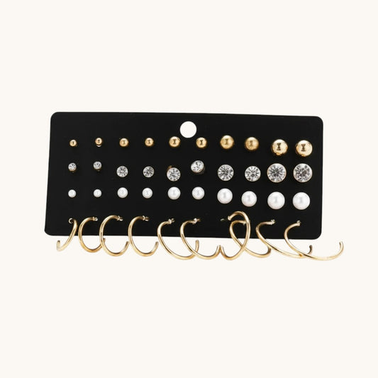 TITLIYA set of 20 earrings featuring gold studs, crystal rhinestones, white pearls, and small gold hoop earrings.